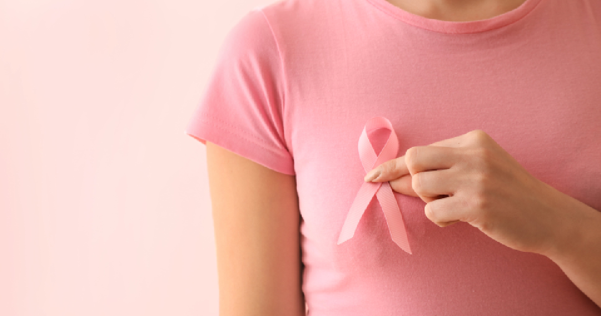A women with pink ribbon showing breast cancer awareness in Dallas, TX